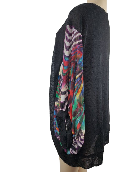 Black sweater with colorful pattern on sleeve on a mannequin against a white background