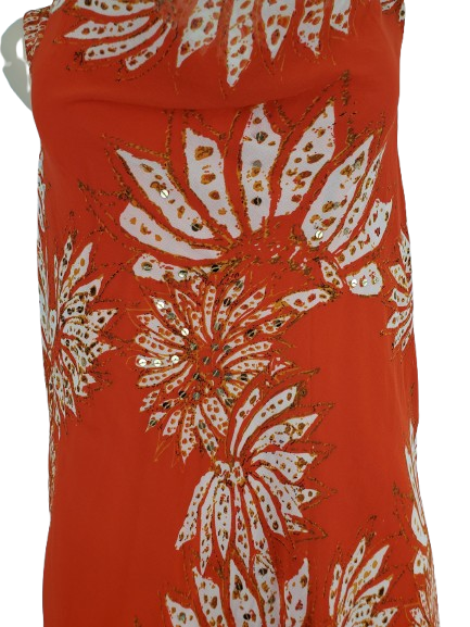 orange dress with white floral pattern on a mannequin against a white background