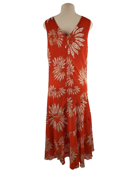 orange dress with white floral pattern on a mannequin against a white backgroundbackground