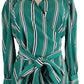 Green and black striped dress on a mannequin with a white background