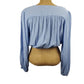 Blue blouse on a mannequin with a white background
