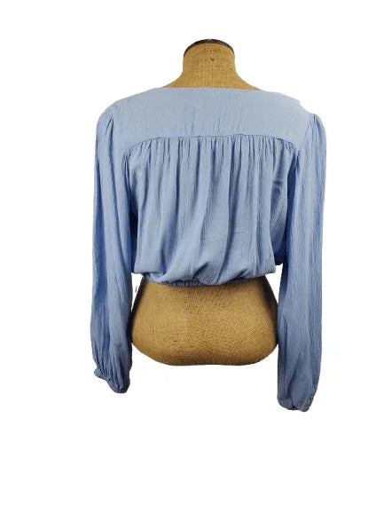 Blue blouse on a mannequin with a white background