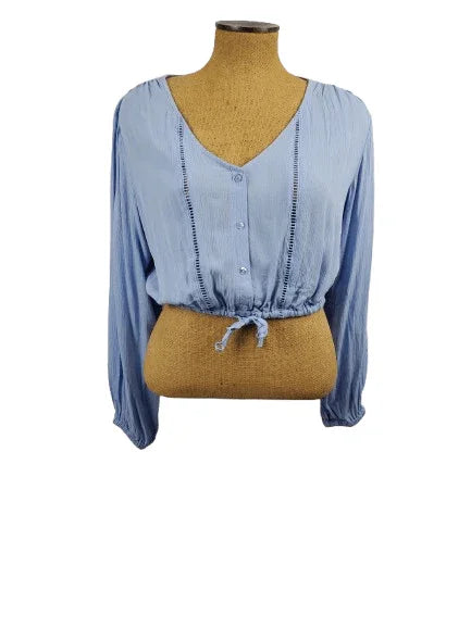 Blue blouse on a mannequin with a white background