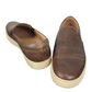 Pair of brown leather slip-on shoes on a white background