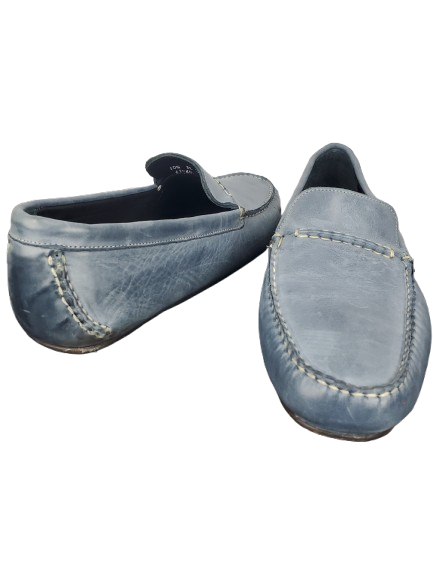Pair of blue loafers on a white background