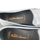 Pair of gray loafers with 'The Super Sport' branding on a white background