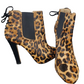 Leopard print ankle boots with black soles on a white background