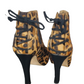 Leopard print high-heeled shoes with black laces on a white background