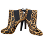 Leopard print ankle boots with black soles on a white background