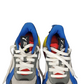 Pair of blue, gray, and red sneakers with white laces on a white background