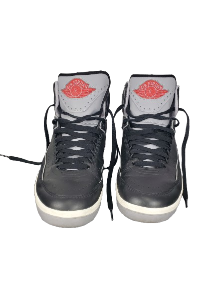 Pair of black high-top sneakers with red logo on a white background