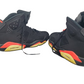 Black sneakers with red and yellow accents on a white background