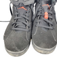 Pair of gray high-top sneakers with orange accents on a white background