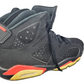 Black high-top sneakers with red and yellow accents on a white background