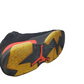 Black, yellow, and red athletic shoe sole on a white background