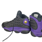 Pair of black and purple sneakers on a white background