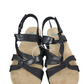 Pair of black strappy sandals on a white background