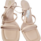 Pair of beige sandals with thin straps on a white background