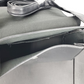 Close-up of a car's side mirror with a strap on a white background