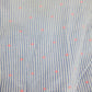 Close-up of a fabric with blue stripes and pink polka dots