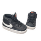 Pair of black high-top sneakers with a white logo on a white background