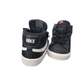 Black Nike sneakers with white soles on a white background