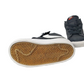 Navy high-top sneakers with white soles on a white background