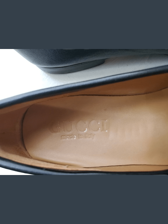 Close-up of a Gucci shoe sole with visible branding.