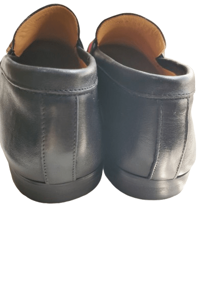 Pair of black leather shoes on a white background