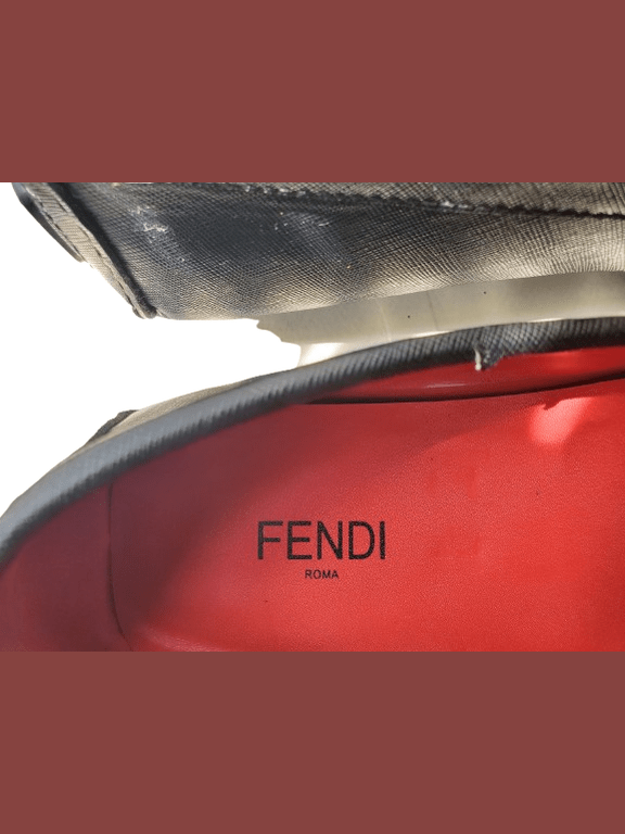 Red Fendi bag with black logo on a white background
