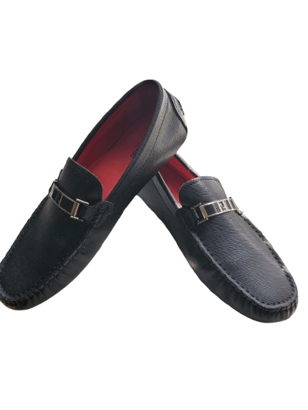 Black loafers with gold buckles on a white background
