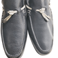 Pair of navy loafers with decorative bows on a white background