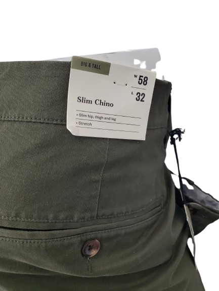 Green chino pants with a size tag on a white background