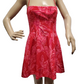 Red dress with white floral pattern on a mannequin against a white background
