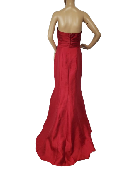 Red strapless evening gown on a mannequin against a white background