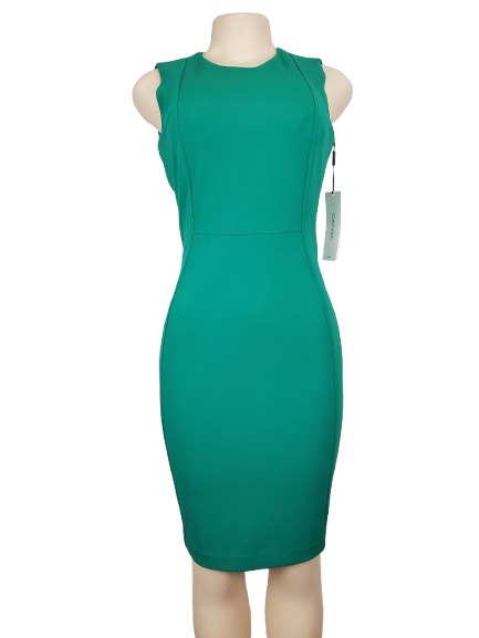 Green dress on a mannequin with a white background