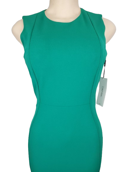 Green dress on a mannequin with a visible tag against a white background