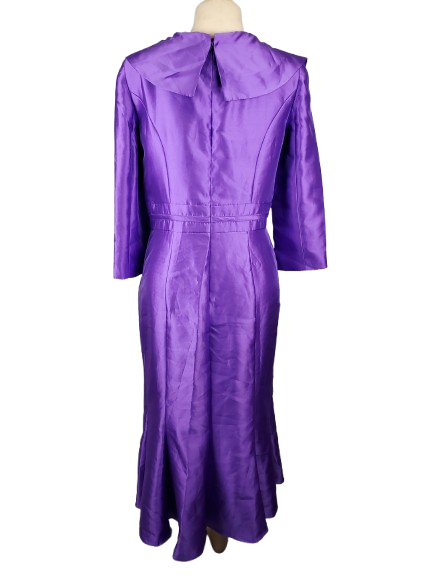 Purple dress on a mannequin against a white background