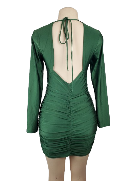 Green dress with open back on a mannequin against a white background