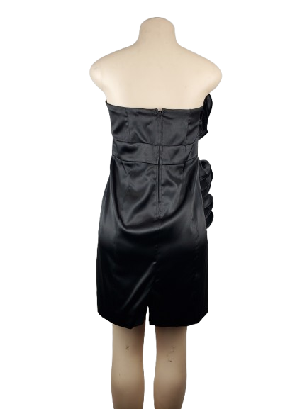 Black strapless dress on a mannequin against a white background
