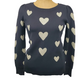 black sweater with heart patterns on a mannequin against a white background