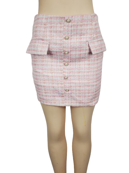 Pink textured skirt with buttons on a mannequin against a white background