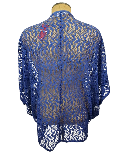 Blue lace shrug on a mannequin against a white background