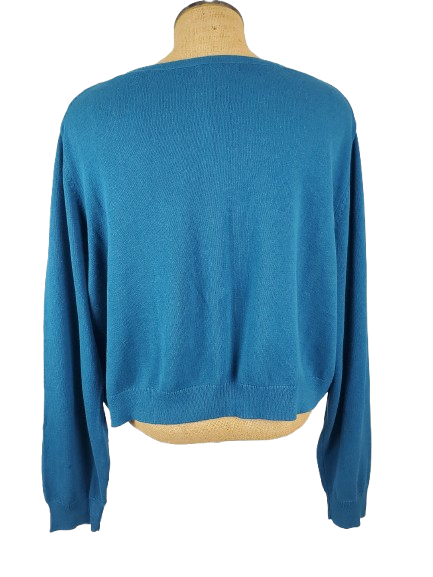 Blue sweater on a mannequin against a white background