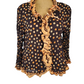 brown blouse with orange polka dots and ruffled trim on a mannequin against a white background