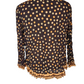 brown blouse with orange polka dot pattern and ruffled collar on a white background