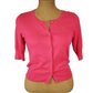 Pink women’s button front short sleeve cardigan sweater displayed on mannequin.