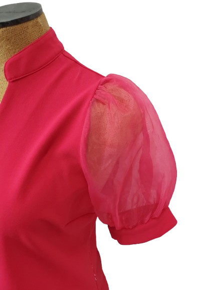 pink blouse with sheer sleeves on a mannequin against a white background