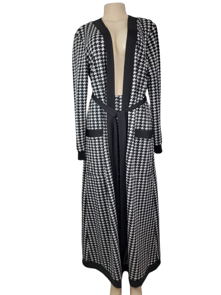 Black and white houndstooth patterned dress on a mannequin against a white background