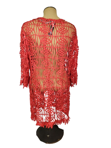 Red crochet dress on a mannequin against a white background